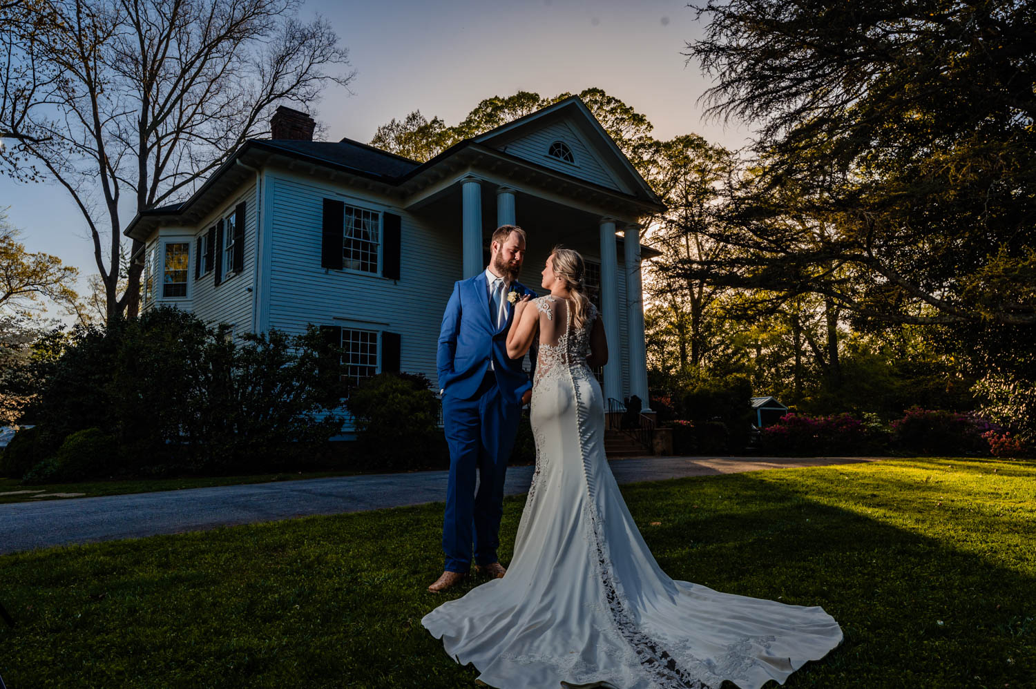 Bride and groom stand on the steps of Duncan Estate, a historic Spartanburg wedding venue.