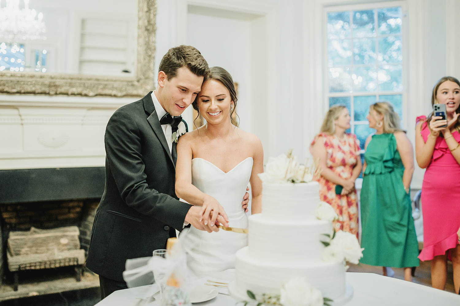 Bride and groom cutting their cake at a wedding reception