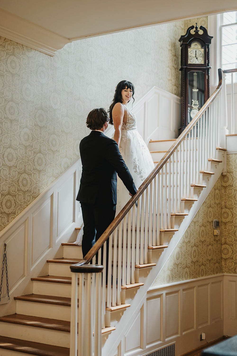 Wife leading a husband up the stairs