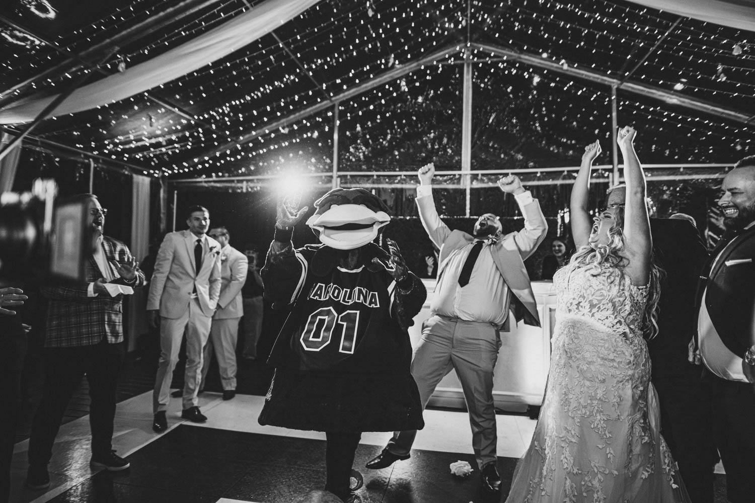 Groom dancing with Cocky USC mascot at wedding