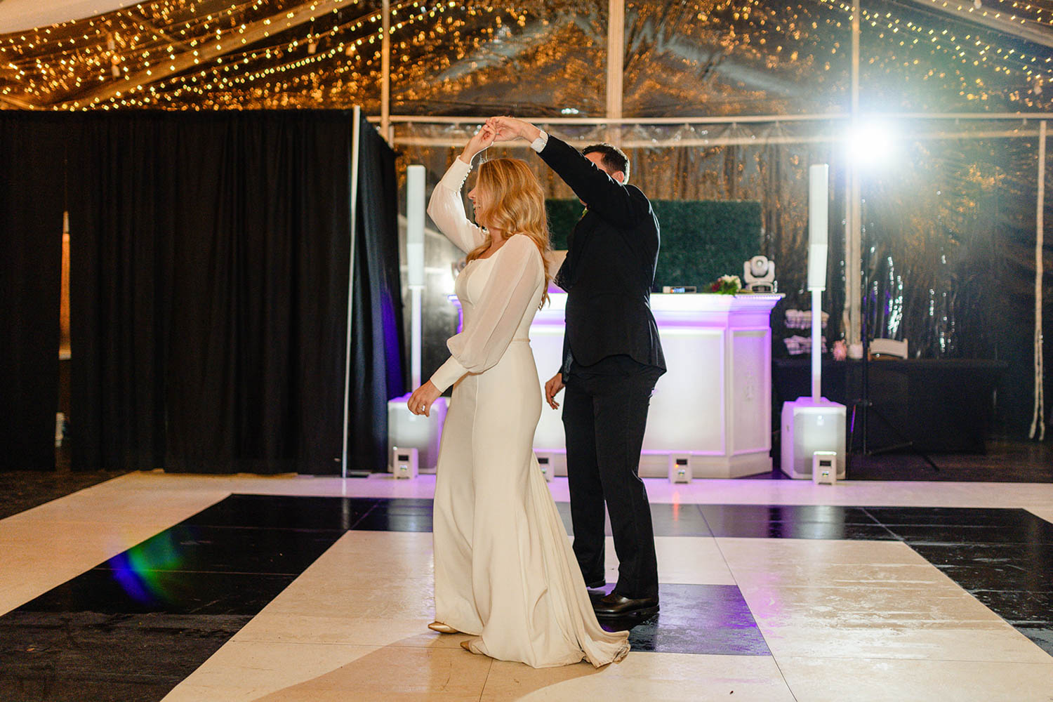 groom twirling bride at wedding reception