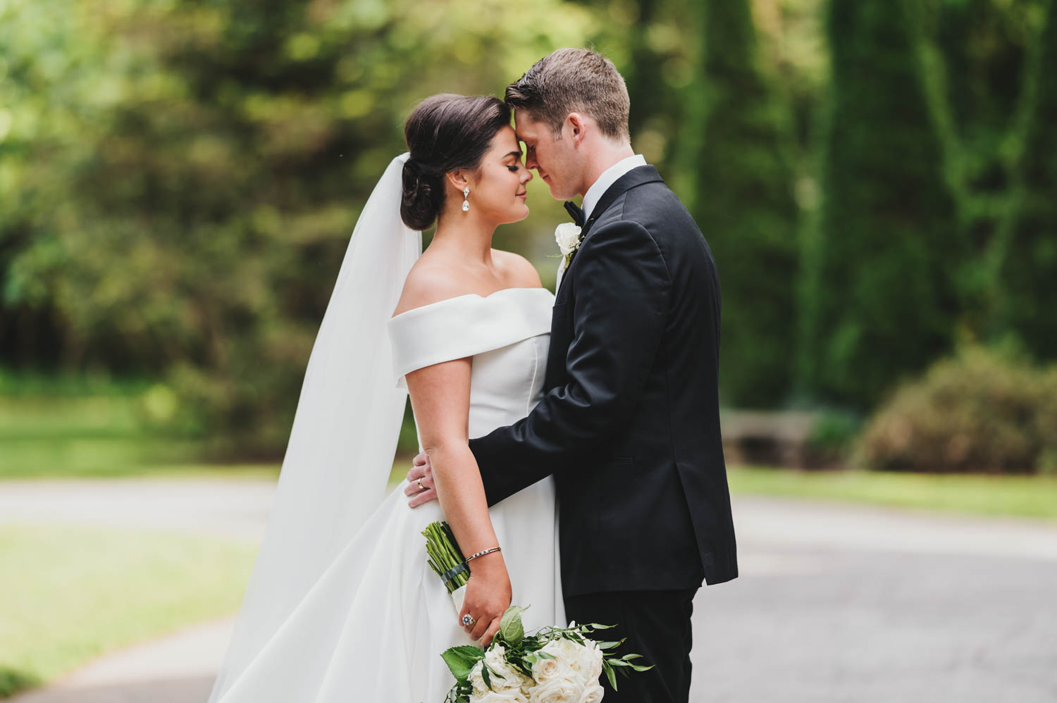 Bride and groom standing forehead to forehead