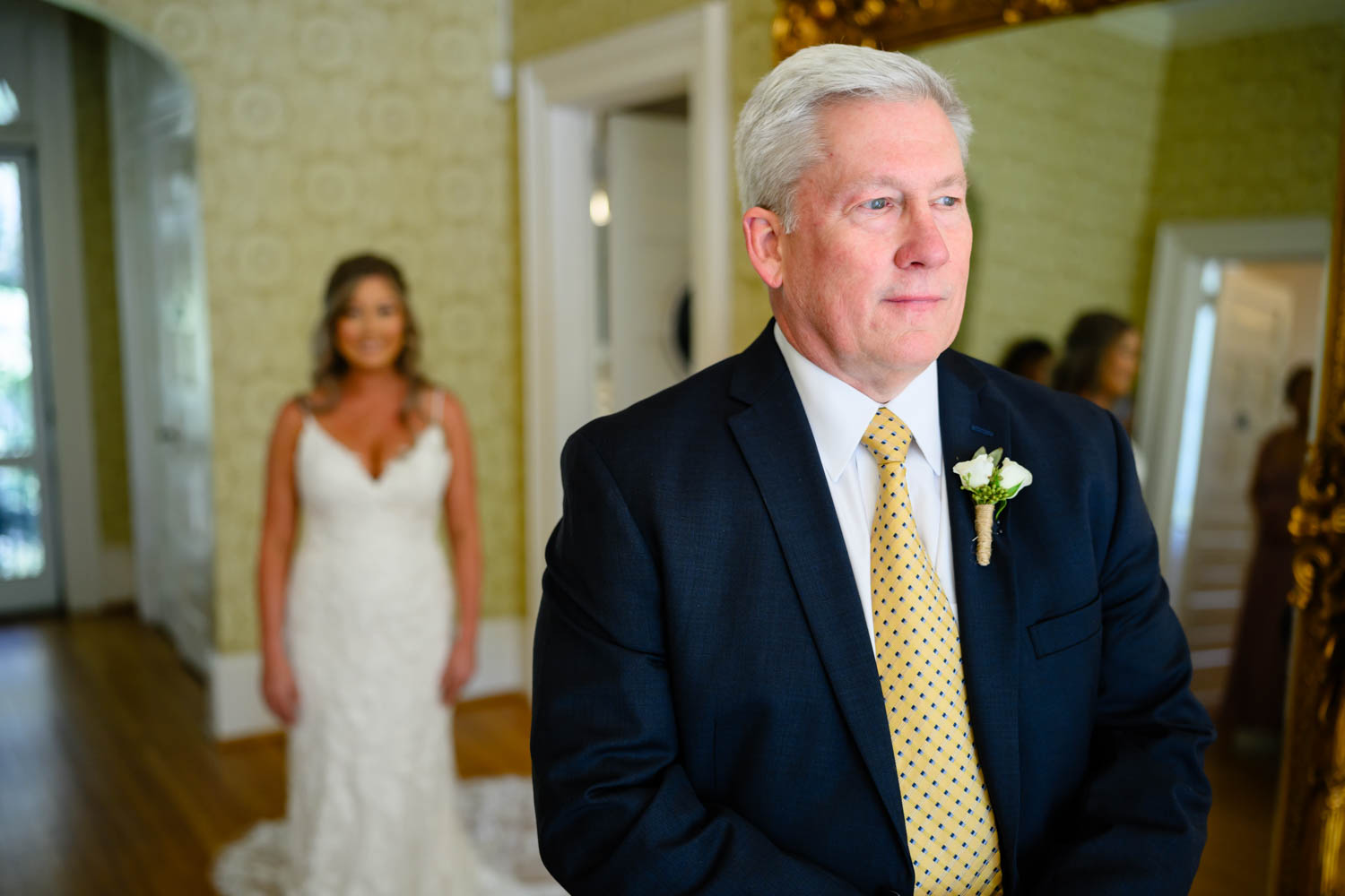 Father and daughter first look with dad looking away from camera