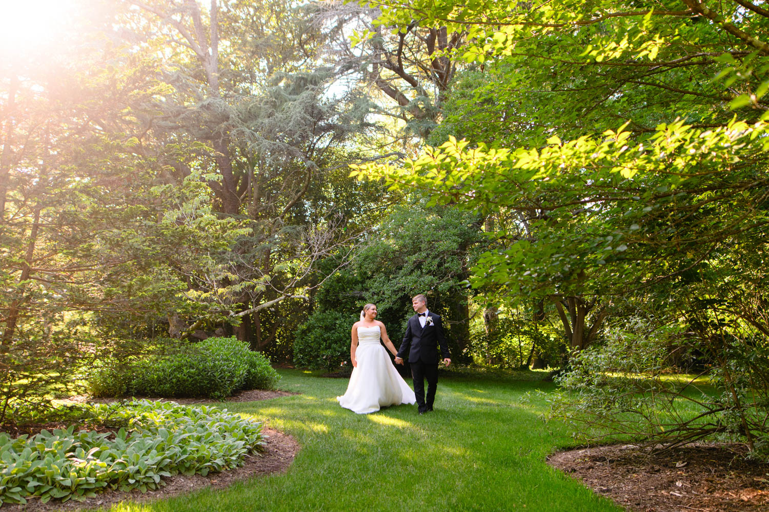 Couple walking through a garden before their wedding