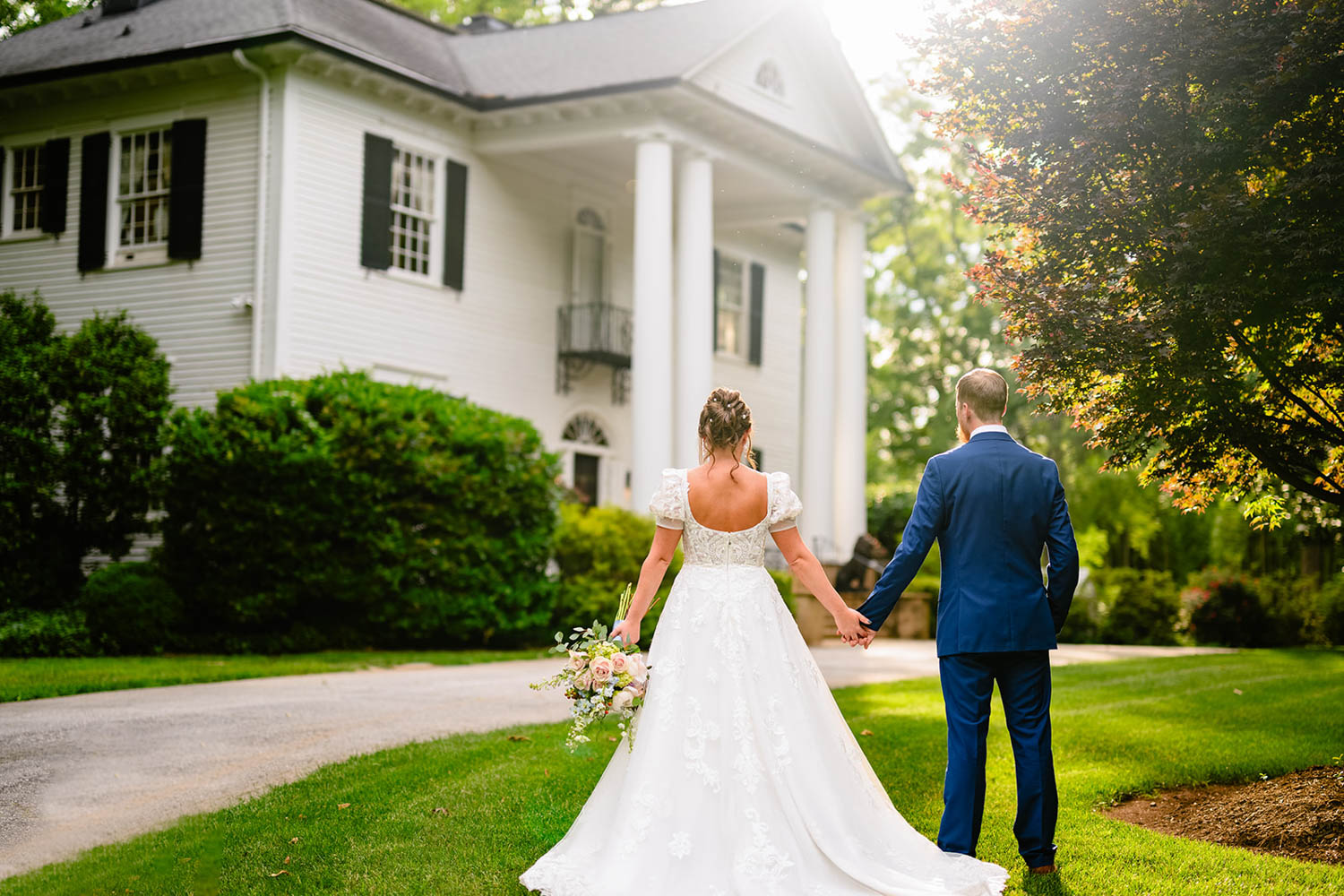 couple facing away from the camera in wedding attire