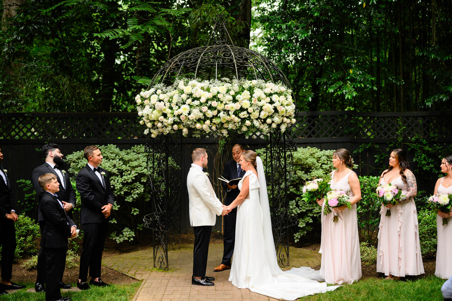 Wedding couple holding hands during wedding ceremony at Duncan Estates