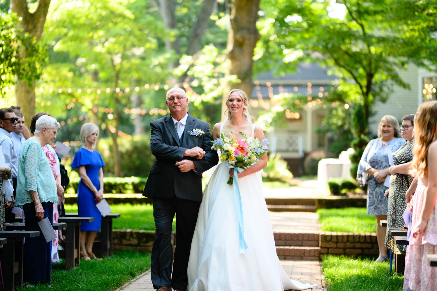 Father walking daughter down the aisle at her wedding