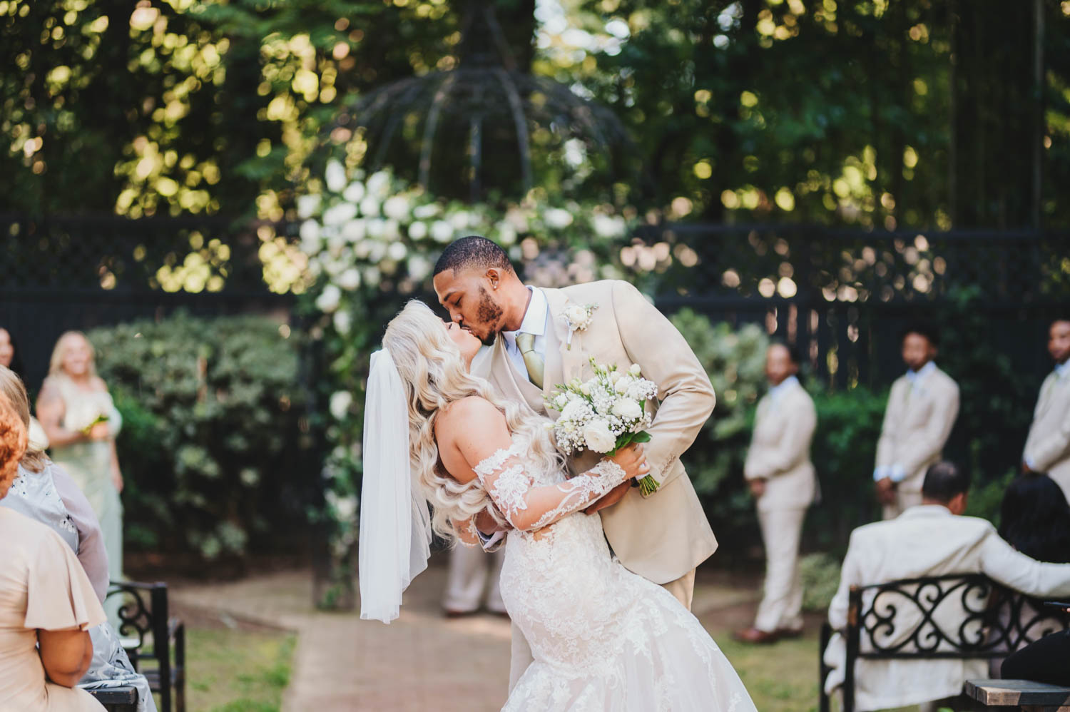 Groom dipping bride for a kiss down the wedding aisle at Duncan Estate