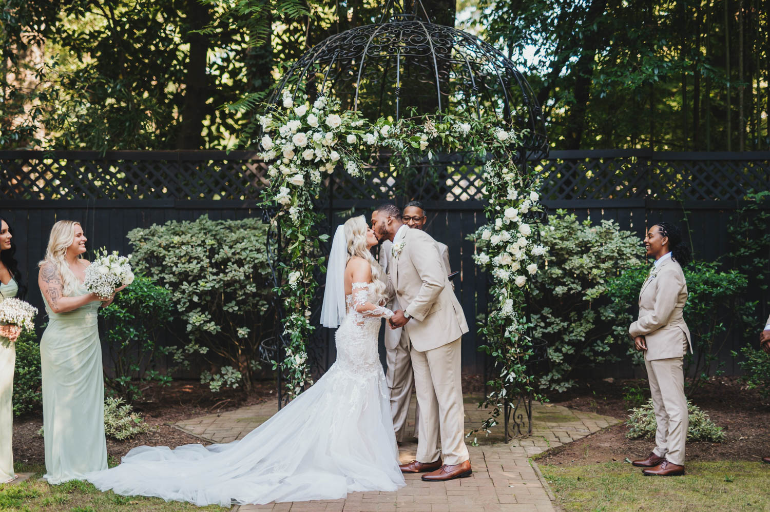 Groom with bride kissing at wedding ceremony