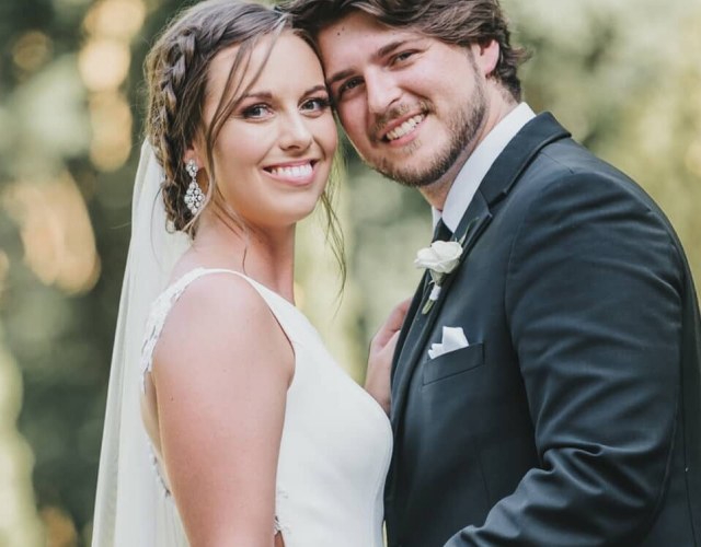 Groom and bride staring at the camera after wedding ceremony