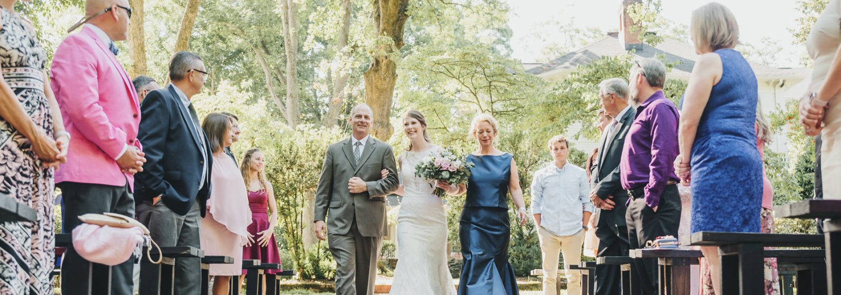 Bride being escorted by parents at Duncan Estate